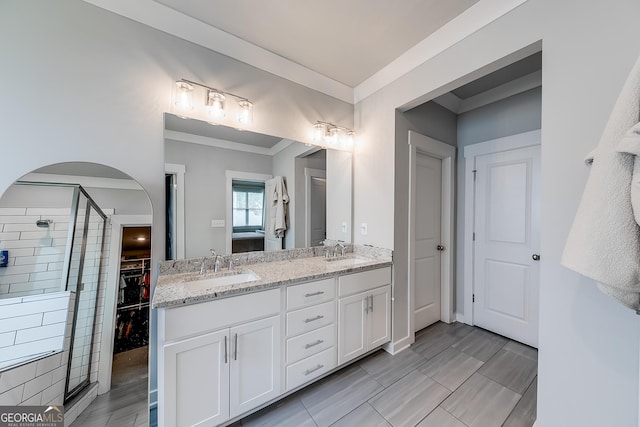 4581 Blacksmith Ln, Jefferson, GA 30549 - full bathroom featuring a shower stall, double vanity, crown molding, and a walk in closet