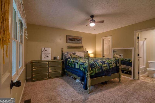 34 Sassafras Grv, Dawsonville, GA 30534 - carpeted bedroom with a textured ceiling, connected bathroom, ceiling fan, and baseboards