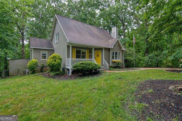 34 Sassafras Grv, Dawsonville, GA 30534 - view of front of house with covered porch, a chimney, central air condition unit, and roof with shingles