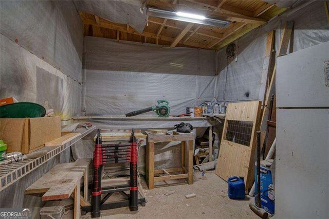 34 Sassafras Grv, Dawsonville, GA 30534 - basement with a workshop area and freestanding refrigerator