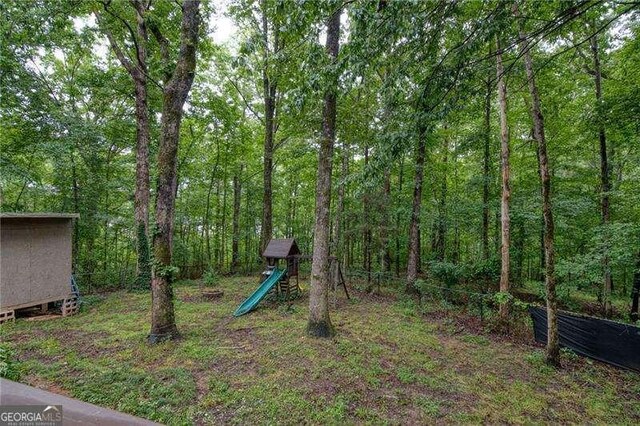 34 Sassafras Grv, Dawsonville, GA 30534 - view of yard with a playground and a view of trees