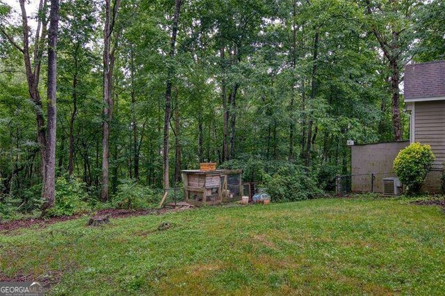 34 Sassafras Grv, Dawsonville, GA 30534 - view of green lawn featuring central AC unit