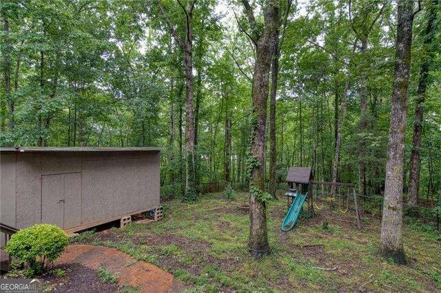 34 Sassafras Grv, Dawsonville, GA 30534 - view of yard with a playground and a forest view