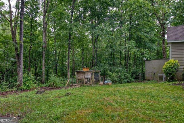 34 Sassafras Grv, Dawsonville, GA 30534 - view of grassy yard with central AC