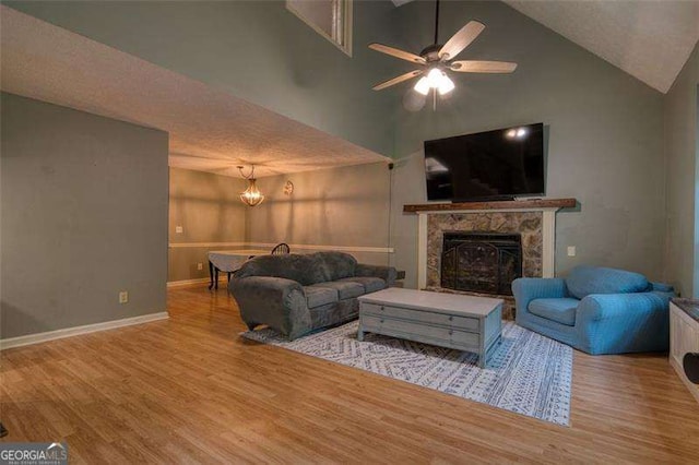 34 Sassafras Grv, Dawsonville, GA 30534 - living area with wood finished floors, high vaulted ceiling, baseboards, a high end fireplace, and a ceiling fan