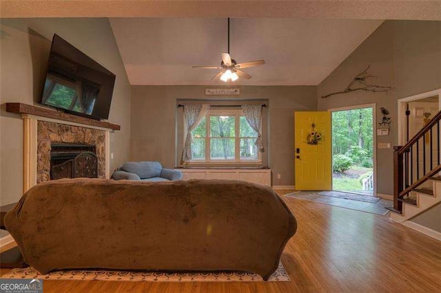 34 Sassafras Grv, Dawsonville, GA 30534 - living area featuring vaulted ceiling, wood finished floors, healthy amount of natural light, and stairs