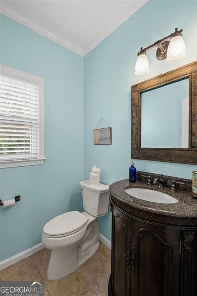 10735 Pinewalk Forest Cir, Alpharetta, GA 30022 - half bath featuring toilet, baseboards, crown molding, vanity, and tile patterned flooring