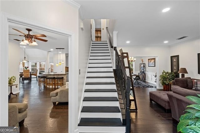 10735 Pinewalk Forest Cir, Alpharetta, GA 30022 - stairway featuring ornamental molding, a ceiling fan, wood finished floors, recessed lighting, and a chandelier