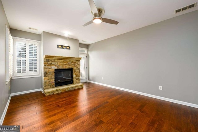 4916 Gathering Pl, Suwanee, GA 30024 - unfurnished living room featuring a ceiling fan, wood finished floors, and a stone fireplace
