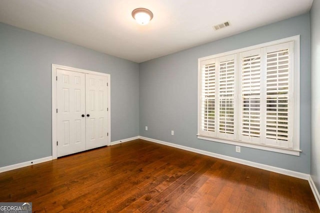 4916 Gathering Pl, Suwanee, GA 30024 - unfurnished bedroom with hardwood / wood-style floors and a closet