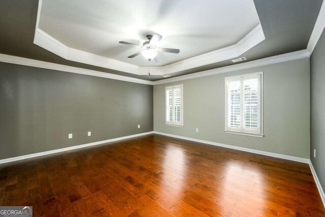 4916 Gathering Pl, Suwanee, GA 30024 - empty room with a tray ceiling, a ceiling fan, ornamental molding, and wood-type flooring