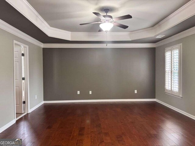 4916 Gathering Pl, Suwanee, GA 30024 - empty room with a raised ceiling, dark wood finished floors, a ceiling fan, and crown molding