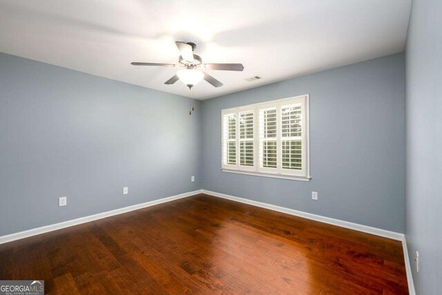 4916 Gathering Pl, Suwanee, GA 30024 - spare room featuring ceiling fan and dark wood-style floors