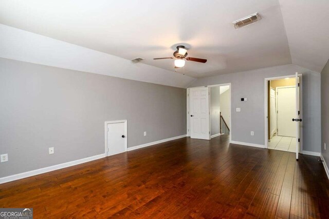 4916 Gathering Pl, Suwanee, GA 30024 - unfurnished bedroom with lofted ceiling, hardwood / wood-style floors, and ceiling fan
