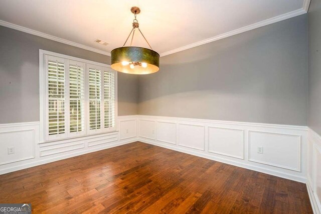 4916 Gathering Pl, Suwanee, GA 30024 - unfurnished dining area with wainscoting, dark wood finished floors, ornamental molding, and a decorative wall