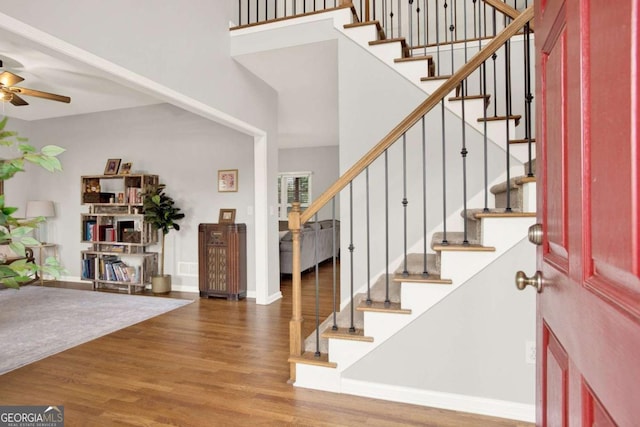 224 Mountain View Dr, Woodstock, GA 30188 - entrance foyer with wood finished floors, a ceiling fan, stairway, and a towering ceiling