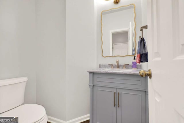 224 Mountain View Dr, Woodstock, GA 30188 - half bathroom featuring vanity, toilet, and baseboards