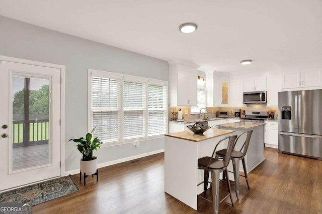 224 Mountain View Dr, Woodstock, GA 30188 - kitchen with stainless steel appliances, a kitchen island, plenty of natural light, and light countertops