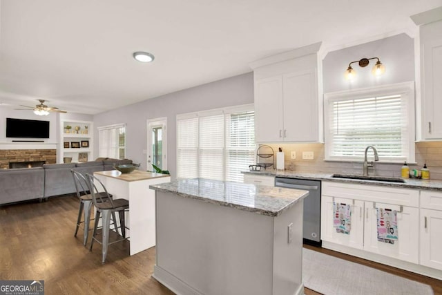 224 Mountain View Dr, Woodstock, GA 30188 - kitchen with stainless steel dishwasher, a sink, a kitchen island, ceiling fan, and dark wood-style floors