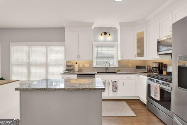 224 Mountain View Dr, Woodstock, GA 30188 - kitchen with appliances with stainless steel finishes, a sink, white cabinetry, and tasteful backsplash