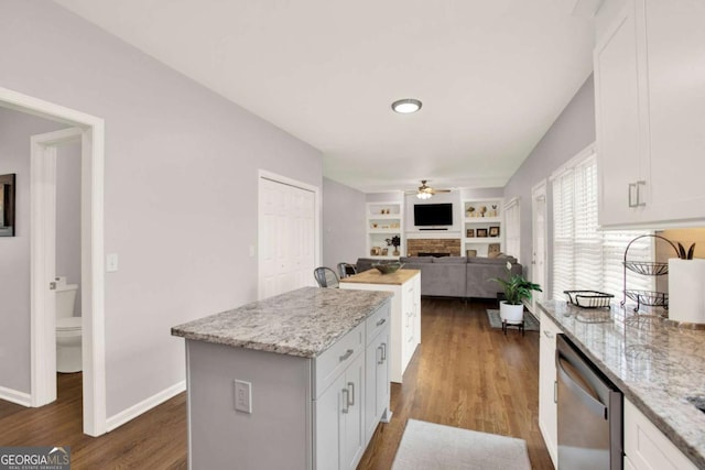 224 Mountain View Dr, Woodstock, GA 30188 - kitchen featuring a fireplace, dishwasher, ceiling fan, a kitchen island, and white cabinetry