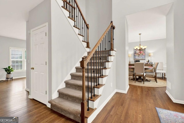 224 Mountain View Dr, Woodstock, GA 30188 - stairs featuring wood finished floors, baseboards, and a chandelier