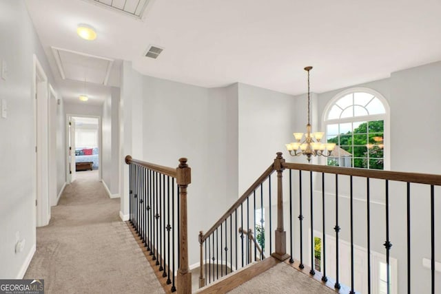 224 Mountain View Dr, Woodstock, GA 30188 - corridor with attic access, an upstairs landing, carpet floors, a chandelier, and baseboards