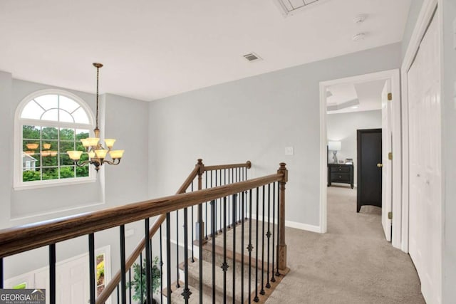224 Mountain View Dr, Woodstock, GA 30188 - corridor with an upstairs landing, light carpet, a chandelier, attic access, and baseboards