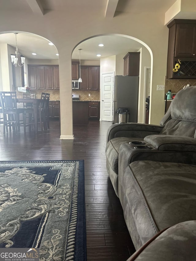 1749 Misselthrush Ln, Mcdonough, GA 30253 - living room featuring dark wood-style flooring, recessed lighting, and arched walkways