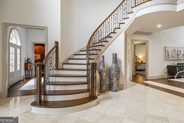 816 Blackfoot Trl, Suwanee, GA 30024 - foyer featuring tile patterned flooring, a towering ceiling, stairway, baseboards, and recessed lighting