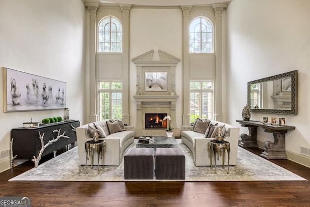 816 Blackfoot Trl, Suwanee, GA 30024 - living room featuring a towering ceiling, plenty of natural light, a high end fireplace, dark wood-style flooring, and baseboards
