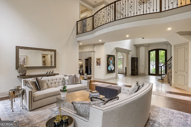 816 Blackfoot Trl, Suwanee, GA 30024 - living area featuring a towering ceiling, wood finished floors, arched walkways, baseboards, and stairway