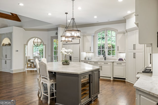 816 Blackfoot Trl, Suwanee, GA 30024 - kitchen with a chandelier, beverage cooler, dark wood-type flooring, white cabinets, and a sink