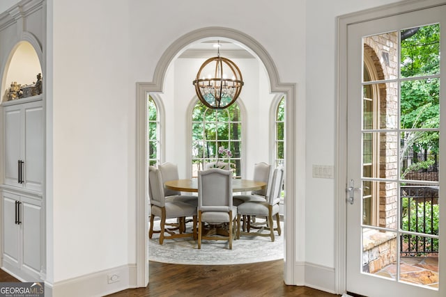 816 Blackfoot Trl, Suwanee, GA 30024 - dining space with a chandelier, dark wood-style flooring, and baseboards
