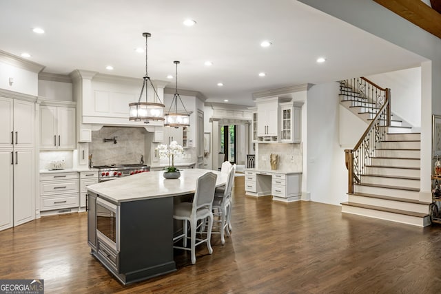 816 Blackfoot Trl, Suwanee, GA 30024 - kitchen with appliances with stainless steel finishes, ornamental molding, light countertops, white cabinets, and glass insert cabinets