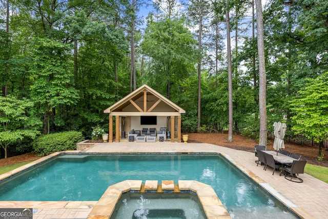 816 Blackfoot Trl, Suwanee, GA 30024 - view of pool with a patio, a pool with connected hot tub, an exterior structure, an outdoor structure, and view of scattered trees