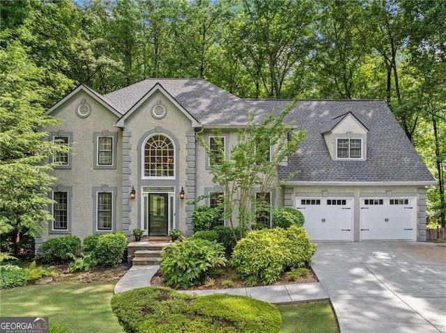 4402 Windsor Oaks Chase, Marietta, GA 30066 - colonial inspired home with driveway, a shingled roof, and view of scattered trees
