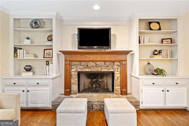 4402 Windsor Oaks Chase, Marietta, GA 30066 - living room featuring light wood-style floors, built in shelves, ornamental molding, and a stone fireplace