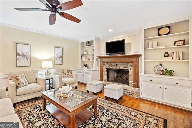 4402 Windsor Oaks Chase, Marietta, GA 30066 - living room with crown molding, light wood finished floors, ceiling fan, a stone fireplace, and built in features