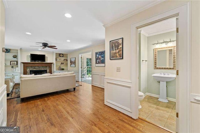 4402 Windsor Oaks Chase, Marietta, GA 30066 - living room featuring a ceiling fan, ornamental molding, a stone fireplace, recessed lighting, and light wood-style floors