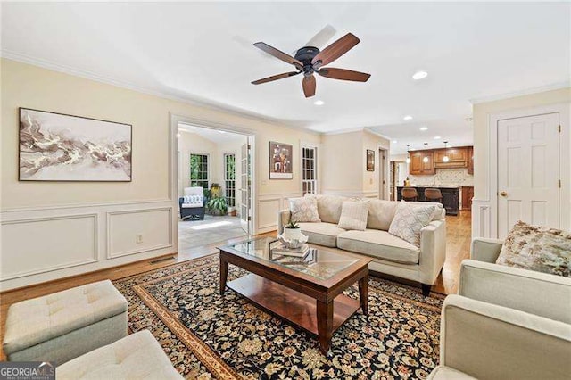 4402 Windsor Oaks Chase, Marietta, GA 30066 - living room featuring crown molding, ceiling fan, recessed lighting, a decorative wall, and wood finished floors
