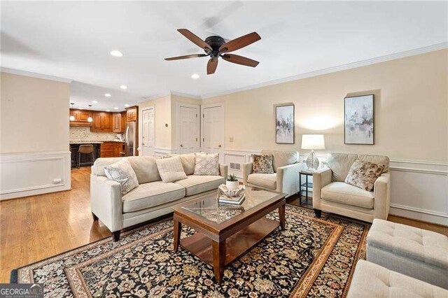 4402 Windsor Oaks Chase, Marietta, GA 30066 - living room with crown molding, ceiling fan, recessed lighting, wainscoting, and light wood finished floors