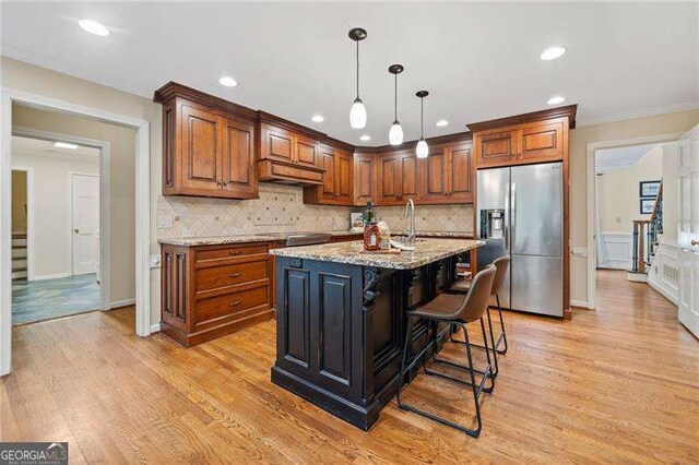 4402 Windsor Oaks Chase, Marietta, GA 30066 - kitchen with stainless steel fridge with ice dispenser, decorative backsplash, light stone counters, light wood-type flooring, and recessed lighting