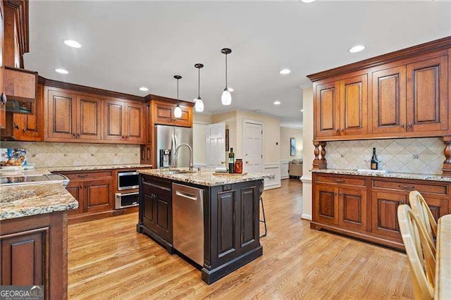 4402 Windsor Oaks Chase, Marietta, GA 30066 - kitchen with stainless steel appliances, tasteful backsplash, light wood-style floors, recessed lighting, and decorative light fixtures