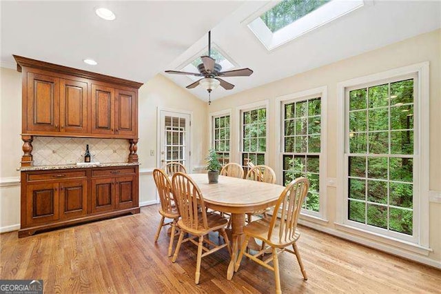 4402 Windsor Oaks Chase, Marietta, GA 30066 - dining room with light wood-style flooring, a skylight, plenty of natural light, a ceiling fan, and vaulted ceiling