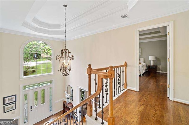 4402 Windsor Oaks Chase, Marietta, GA 30066 - hall with a chandelier, wood finished floors, crown molding, a tray ceiling, and an upstairs landing