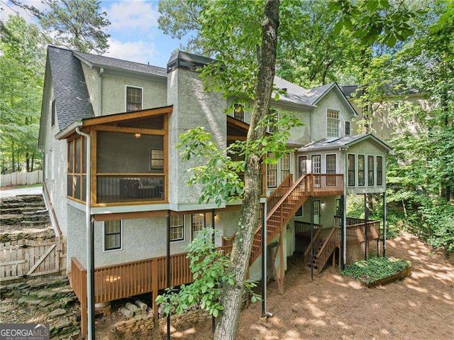 4402 Windsor Oaks Chase, Marietta, GA 30066 - back of property featuring a sunroom, stairs, stucco siding, a wooden deck, and a chimney
