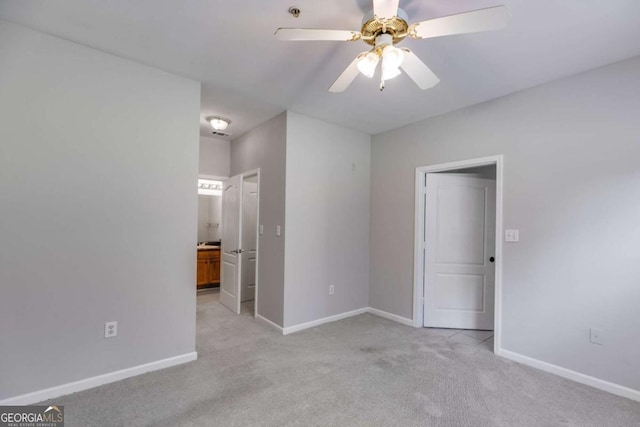 7712 Autry Cir Unit 701, Douglasville, GA 30134 - unfurnished bedroom with light colored carpet, baseboards, ensuite bath, and ceiling fan