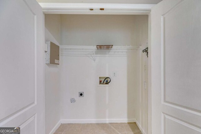 7712 Autry Cir Unit 701, Douglasville, GA 30134 - washroom with electric dryer hookup, hookup for a washing machine, light tile patterned flooring, and baseboards
