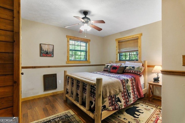 488 S Lemmon Ln Unit 289, Ellijay, GA 30540 - bedroom featuring wood finished floors, multiple windows, heating unit, and ceiling fan
